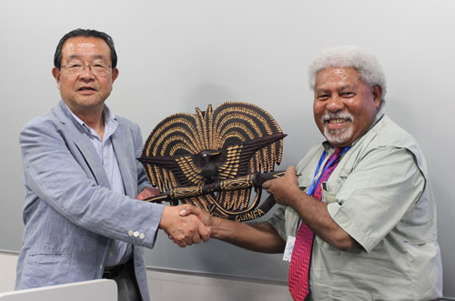 Mr. Madako Suwari, Vice President of KCGI Terashita and Principal of KCG Kyoto Ekimae School, receiving a gift from Mr. Madako Suwari, Ministry of Education, Papua New Guinea