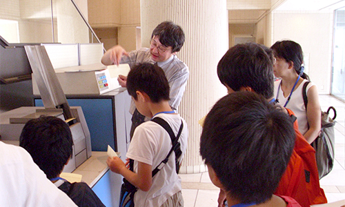 Children listening to Dr. Hiroto Chiba's explanation