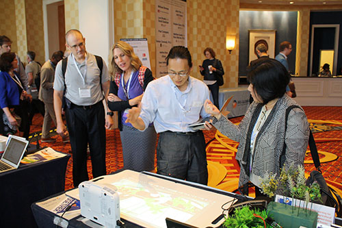 Dr. Kobayashi explains about the horizontal projection type electronic blackboard