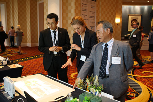 Professor Hong Seung Ko (right) and Associate Professor Ming Hu (left) explain to a visitor