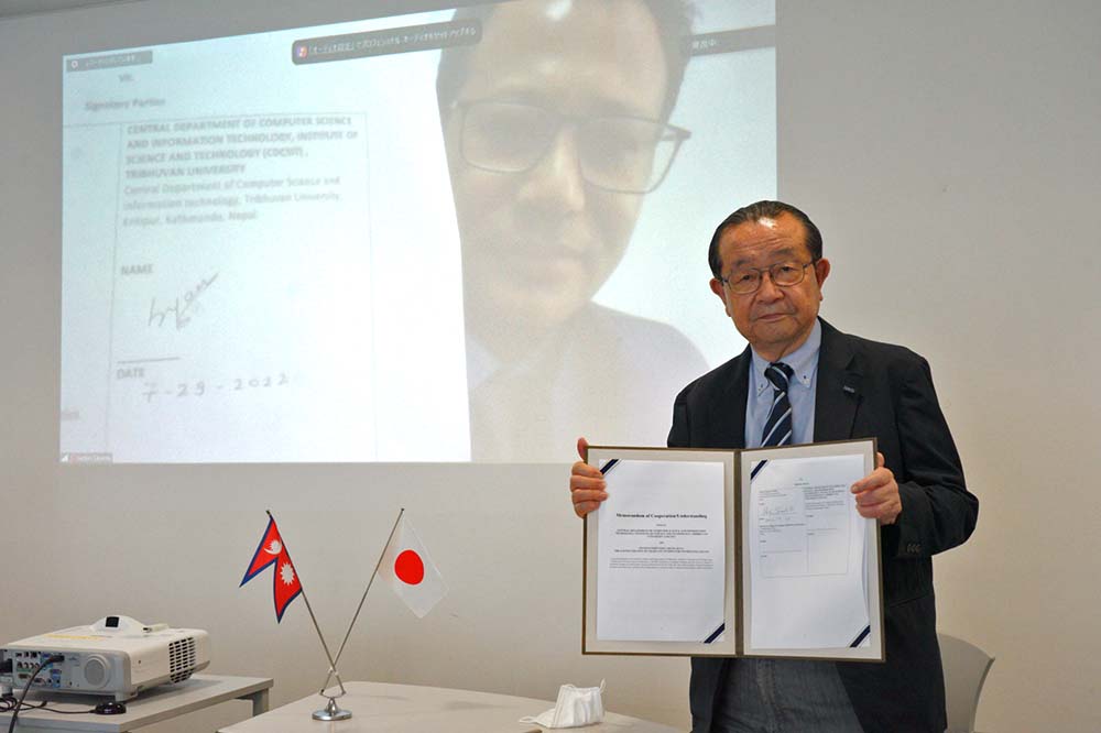 KCG Principal Yoichi Terashita after signing the agreement.Behind screen is Salvin Sayami, Director of TU-CDCSIT Center