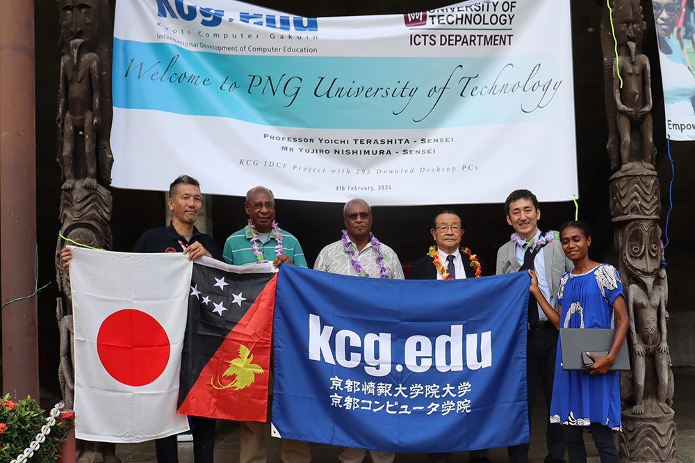 Commemorative photo in front of the KCG welcome banner in front of the auditorium